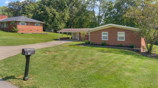 ranch-style house featuring a carport and a front yard