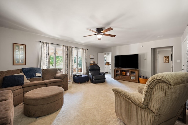 carpeted living room with ceiling fan