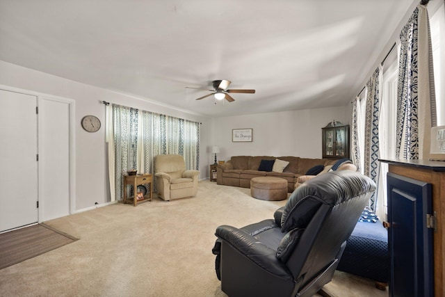 living room with ceiling fan and carpet flooring