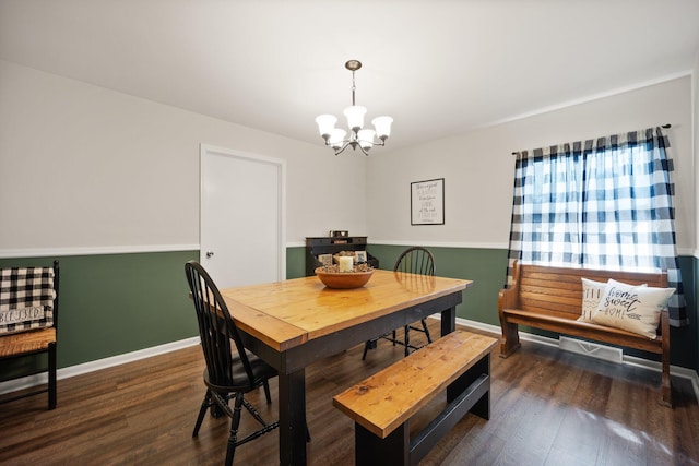 dining space with dark wood-type flooring and a chandelier