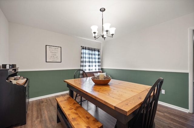 dining room featuring dark hardwood / wood-style floors and a chandelier