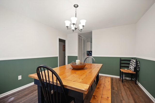 dining area featuring a chandelier and dark hardwood / wood-style flooring