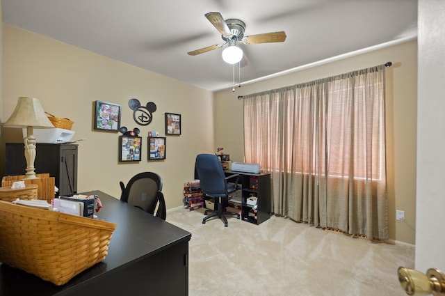 office area featuring light carpet and ceiling fan