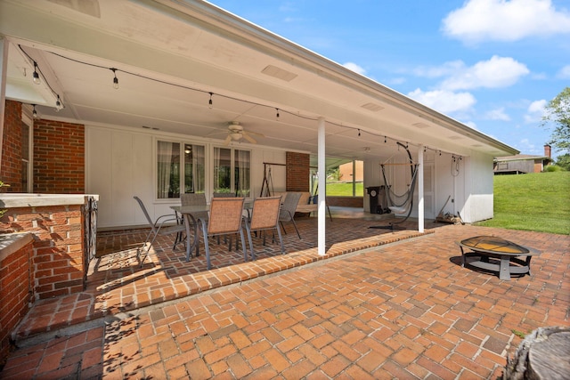 view of patio / terrace with ceiling fan and an outdoor fire pit