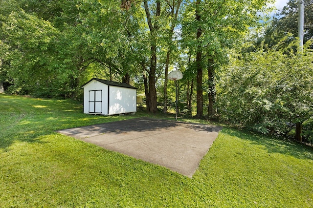 exterior space with a storage shed and basketball hoop