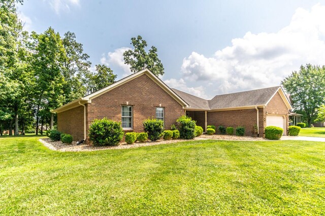 single story home with a garage and a front yard