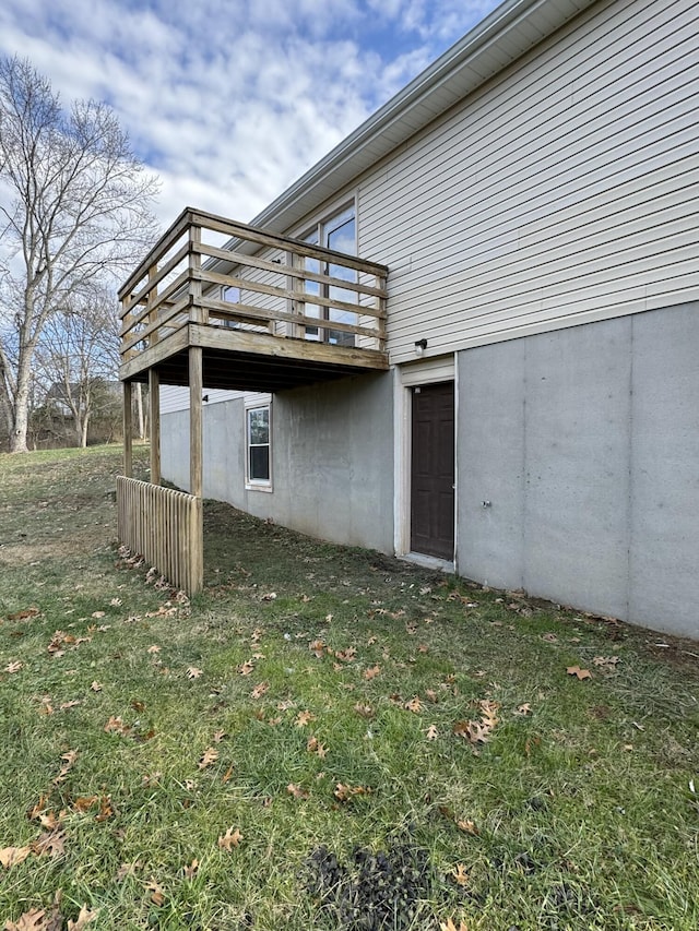 view of side of property with a deck and a yard