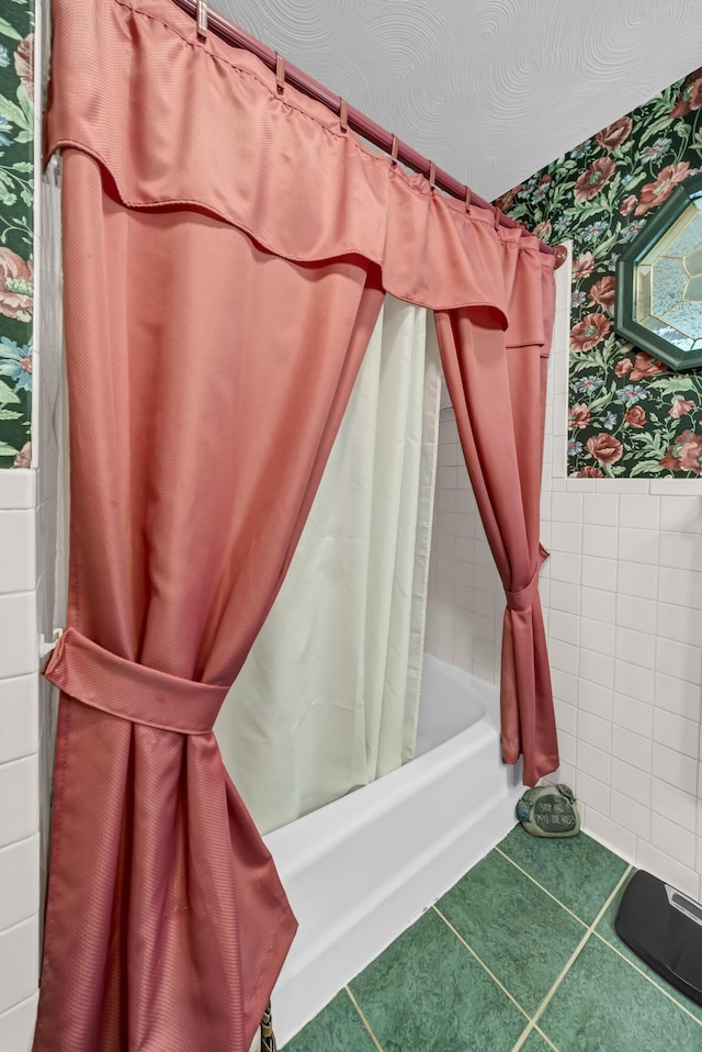 175 N Bend Rd, Stanton, KY 40380 - full bath featuring wallpapered walls, shower / bath combo with shower curtain, wainscoting, tile walls, and tile patterned floors