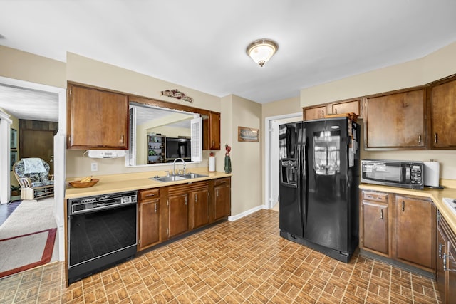 175 N Bend Rd, Stanton, KY 40380 - kitchen with black appliances, a sink, brick patterned flooring, light countertops, and baseboards