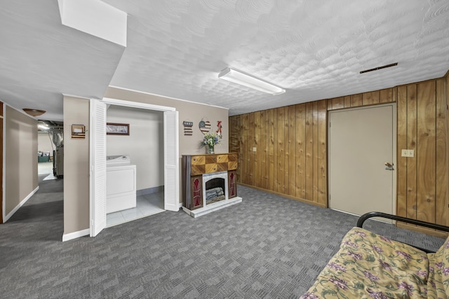 175 N Bend Rd, Stanton, KY 40380 - carpeted living room with washer / dryer, wooden walls, a fireplace with raised hearth, and baseboards