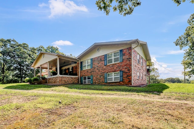 175 N Bend Rd, Stanton, KY 40380 - view of side of property with brick siding, a lawn, and a ceiling fan