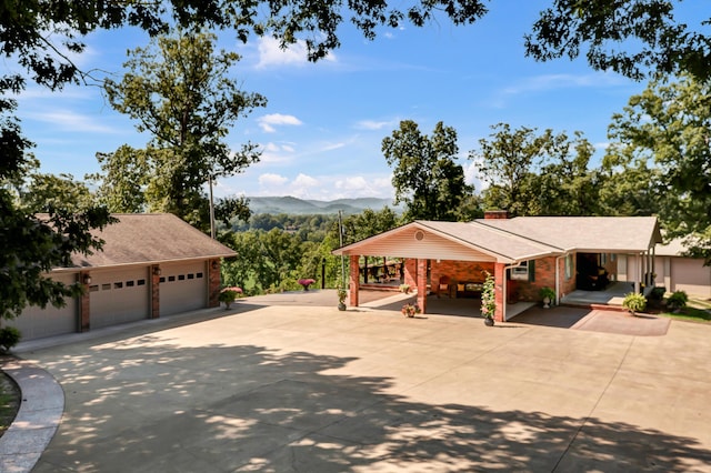 175 N Bend Rd, Stanton, KY 40380 - view of front of home featuring concrete driveway, a mountain view, roof with shingles, brick siding, and a chimney
