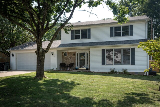 front of property with a garage and a front yard