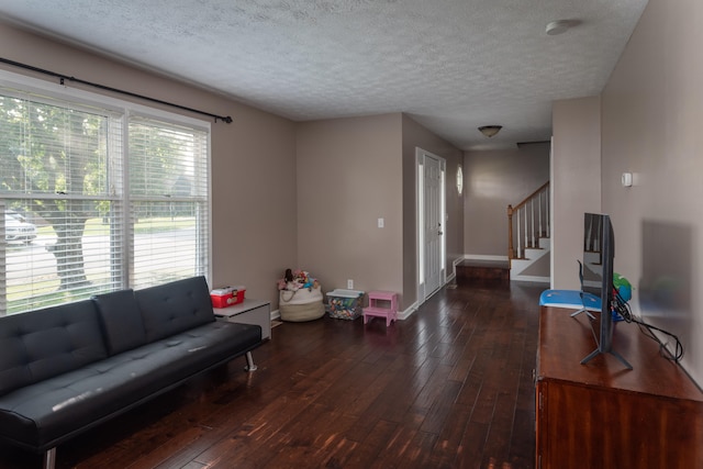 living room with hardwood / wood-style flooring and a textured ceiling