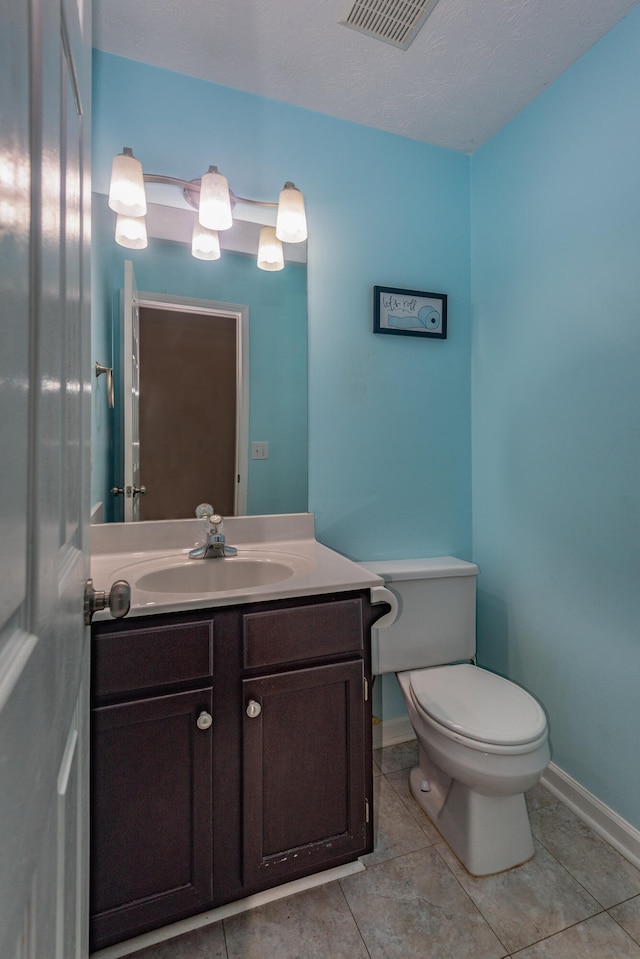 bathroom with tile patterned floors, toilet, and vanity