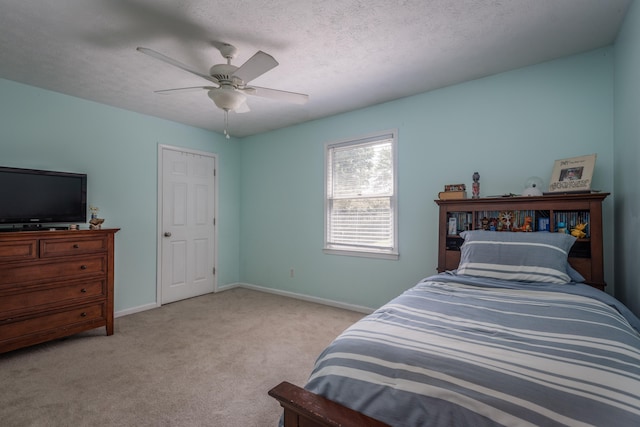 bedroom with light colored carpet, a textured ceiling, and ceiling fan