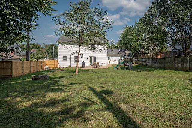 view of yard with a playground and an outdoor fire pit