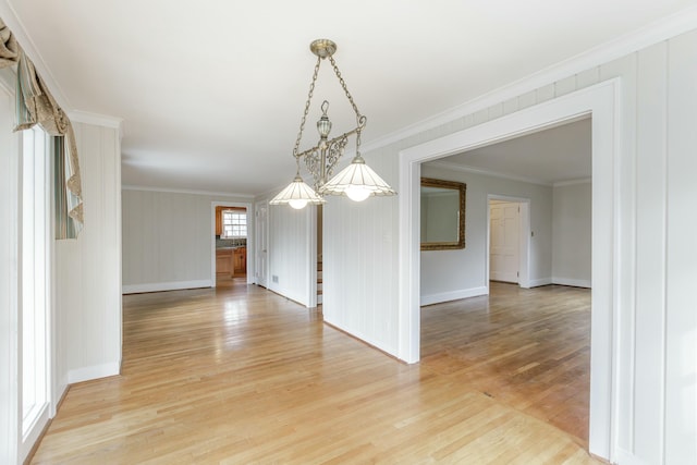 unfurnished dining area with crown molding and hardwood / wood-style floors