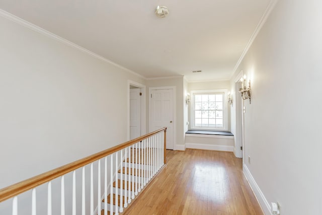 hall with crown molding and light hardwood / wood-style flooring