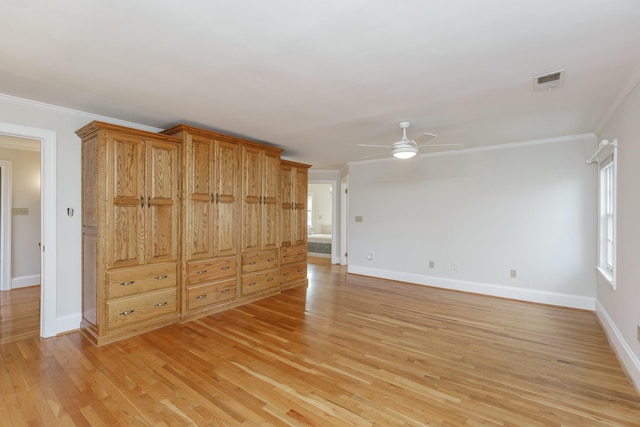 spare room featuring crown molding, ceiling fan, and light hardwood / wood-style floors