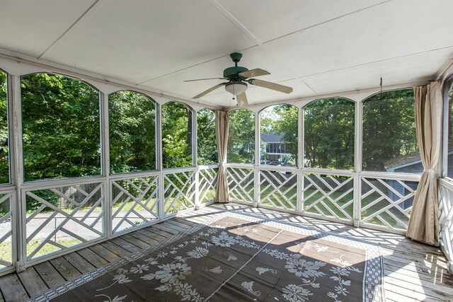 unfurnished sunroom with ceiling fan