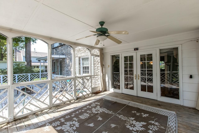 unfurnished sunroom featuring french doors and ceiling fan