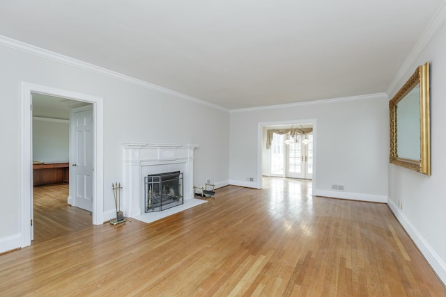 unfurnished living room with crown molding, french doors, and light wood-type flooring