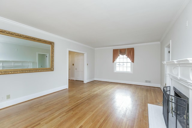 unfurnished living room featuring light hardwood / wood-style flooring and ornamental molding