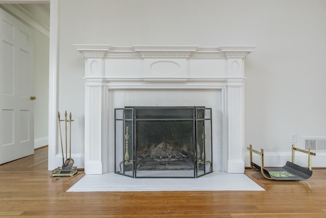 interior details featuring hardwood / wood-style floors and a fireplace