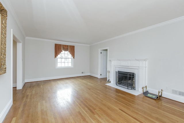 unfurnished living room featuring crown molding and light hardwood / wood-style floors