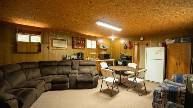 carpeted living room featuring a wall unit AC, wooden walls, plenty of natural light, and a textured ceiling