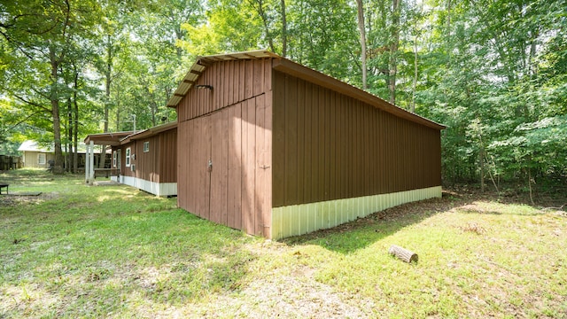 view of outbuilding featuring a lawn