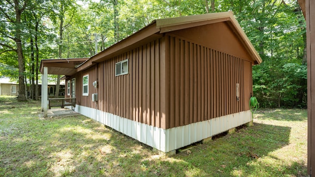 view of property exterior with a lawn