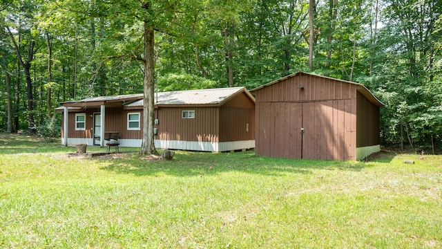 exterior space with a lawn and a shed