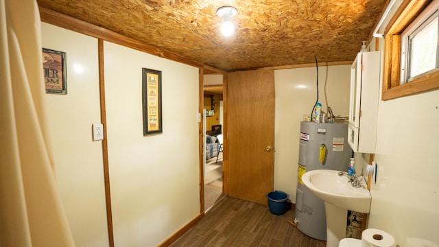 bathroom featuring electric water heater and hardwood / wood-style floors