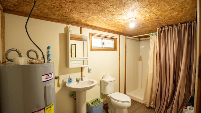 bathroom with water heater, a shower with curtain, and toilet