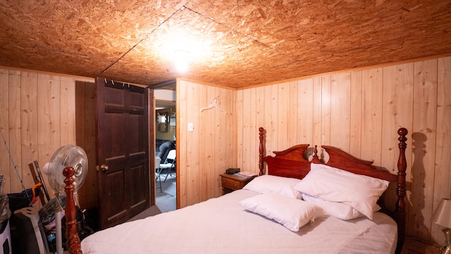 bedroom featuring wood walls