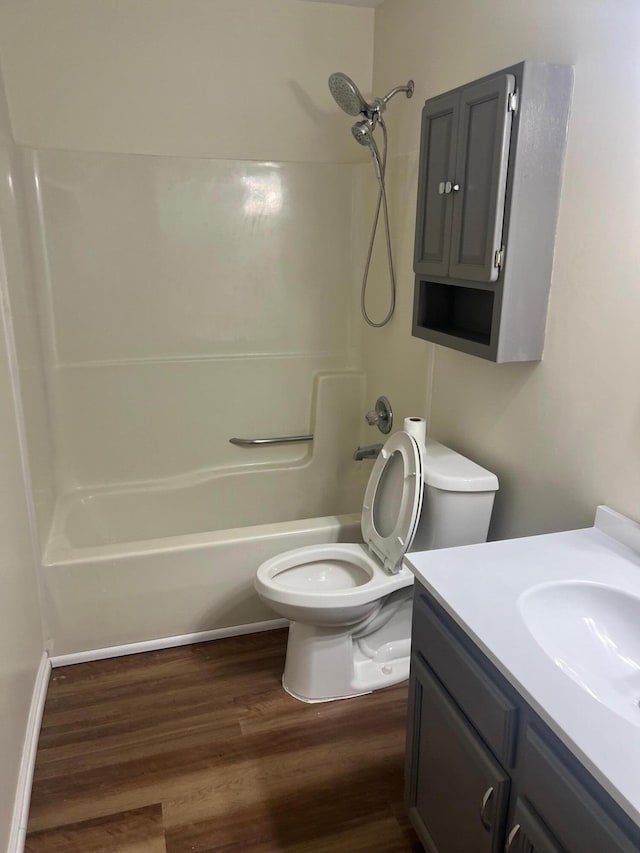 full bathroom featuring vanity, hardwood / wood-style floors, shower / tub combination, and toilet