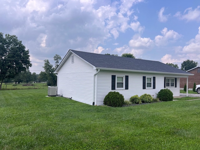 view of side of property with a lawn