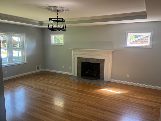 unfurnished living room with wood-type flooring and a wealth of natural light