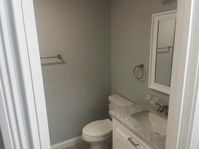 bathroom featuring toilet and vanity