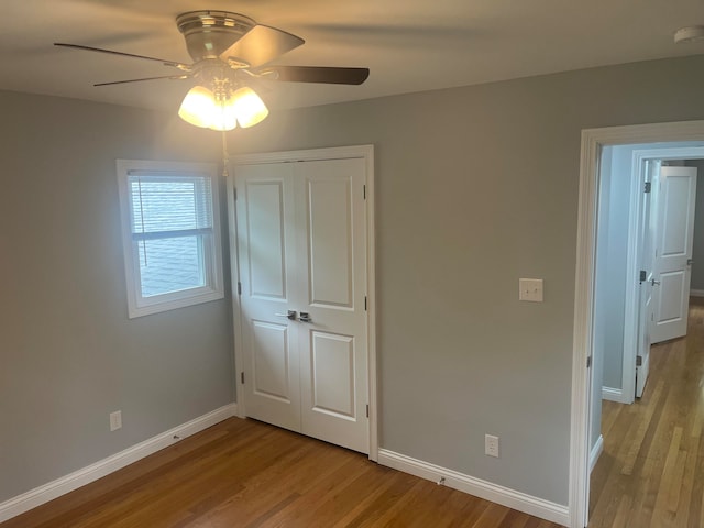 unfurnished bedroom featuring ceiling fan, light hardwood / wood-style flooring, and a closet