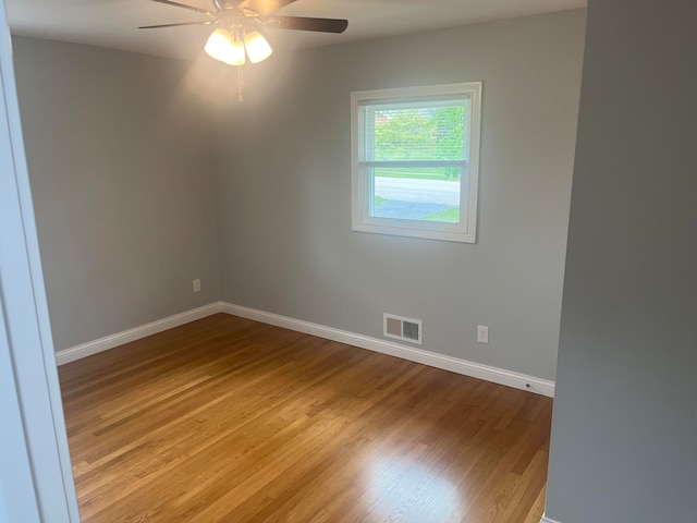 unfurnished room with hardwood / wood-style floors and ceiling fan