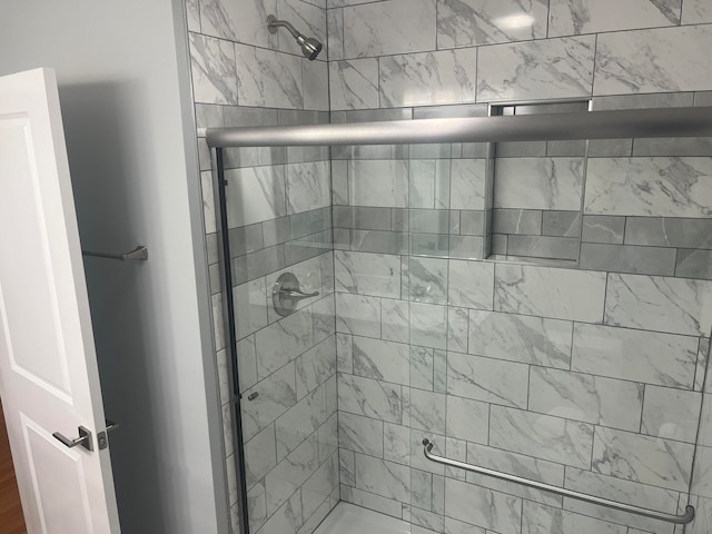 bathroom with a shower with shower door