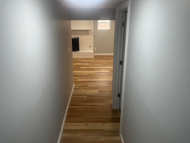 hallway with hardwood / wood-style floors