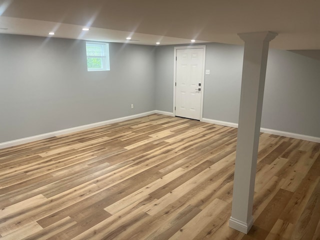 basement with light hardwood / wood-style flooring