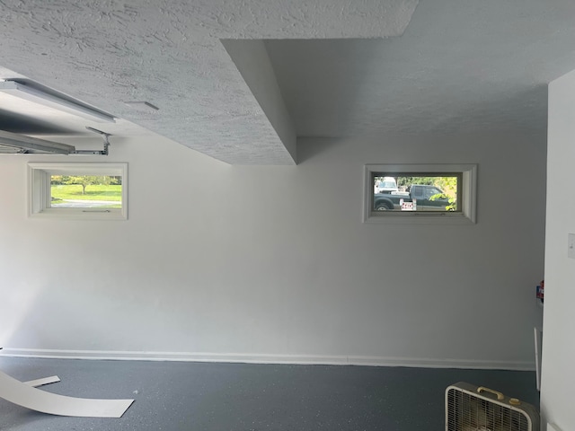 interior space with a wealth of natural light and a textured ceiling