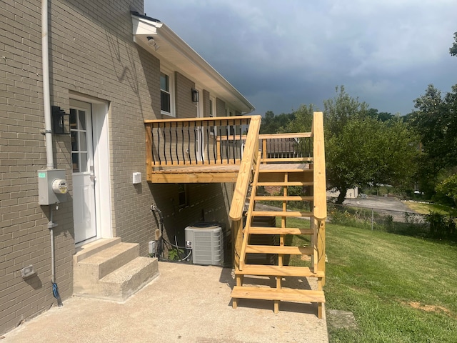 exterior space with a lawn and central air condition unit