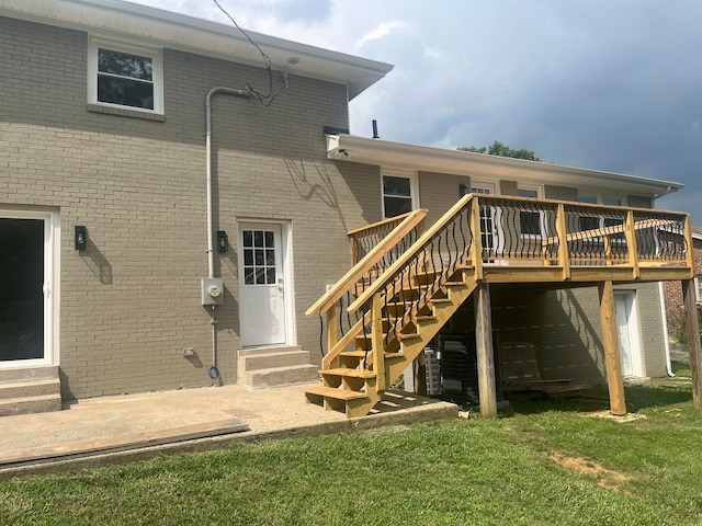 back of house with a yard and a deck