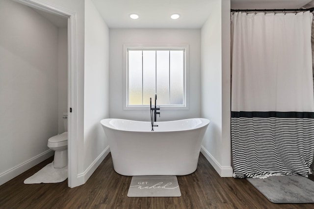 bathroom with wood-type flooring and toilet